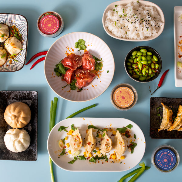 A plate of Gyozas, sticky rice, dim sums, and more